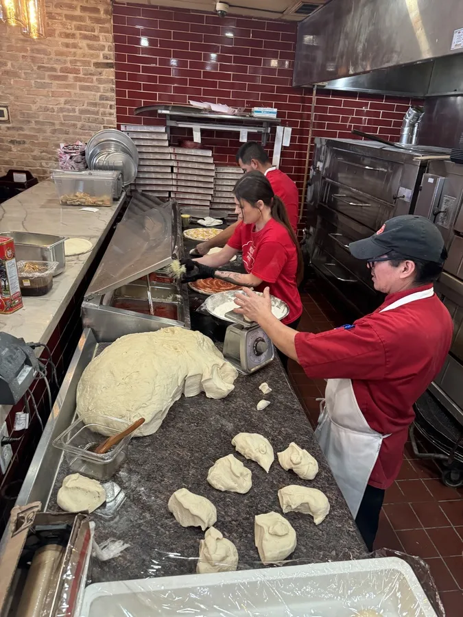 Pizza preparation at the Russo's kitchen work station