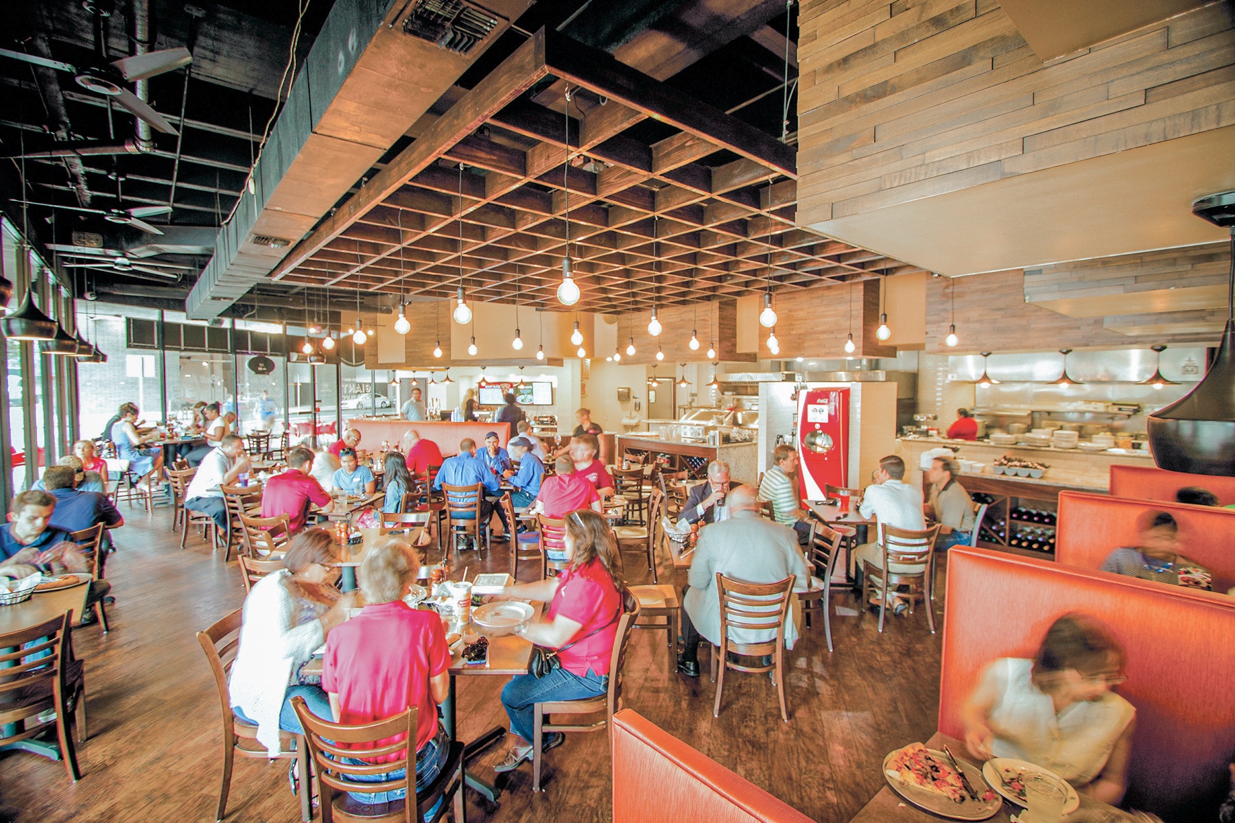 Families dining inside a Russo's New York Pizzeria restaurant